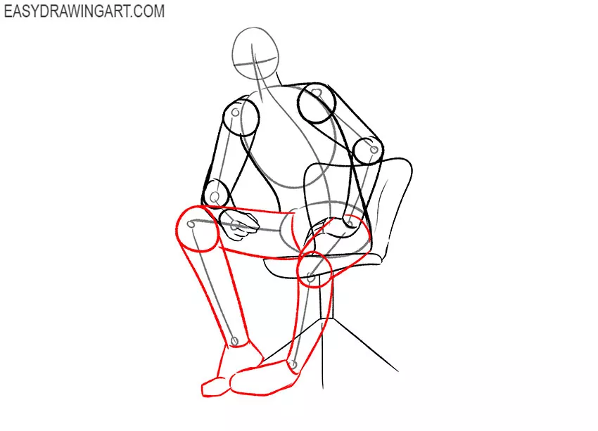 man sitting down drawing